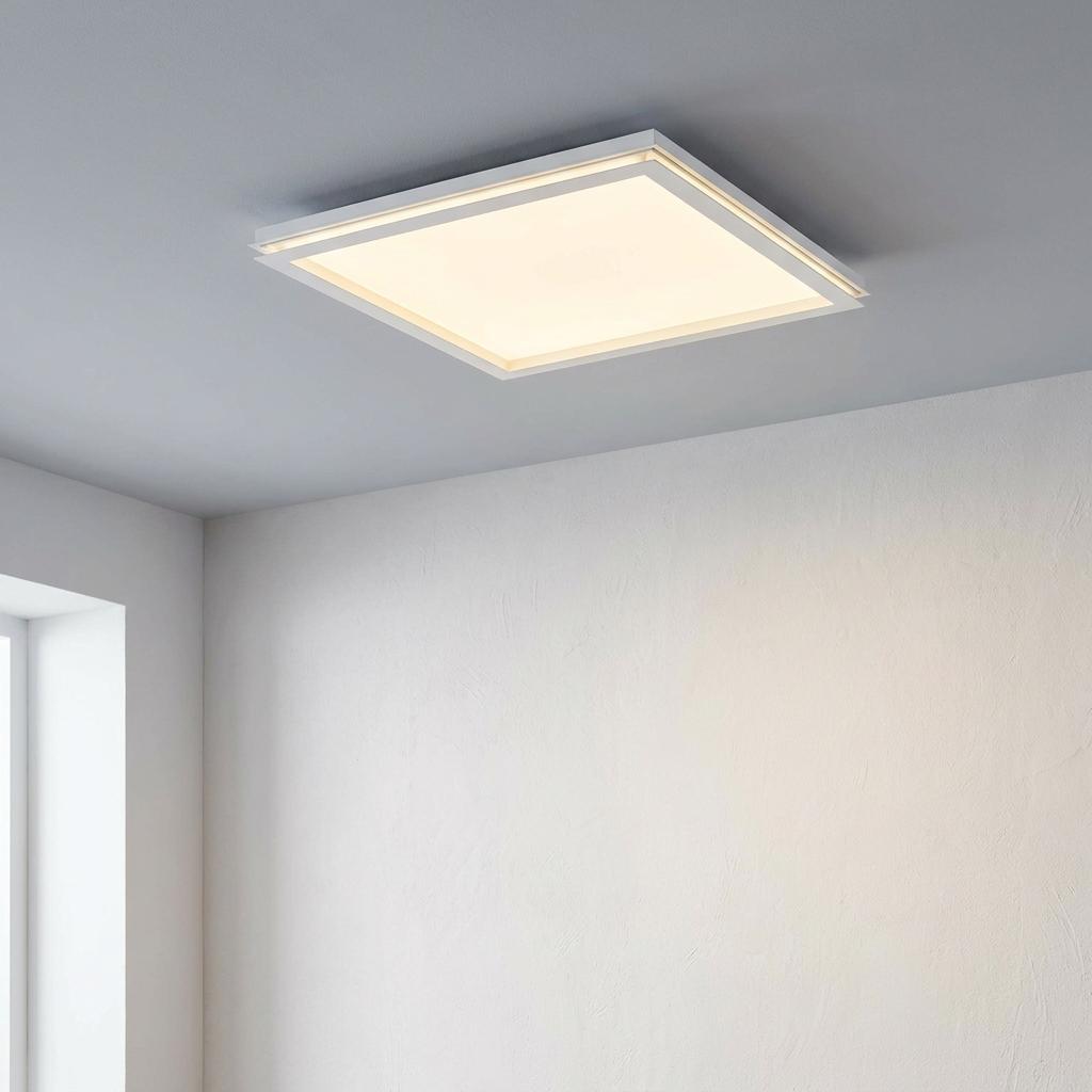 Modern square white LED flush ceiling light with a warm glow mounted on a plain ceiling.