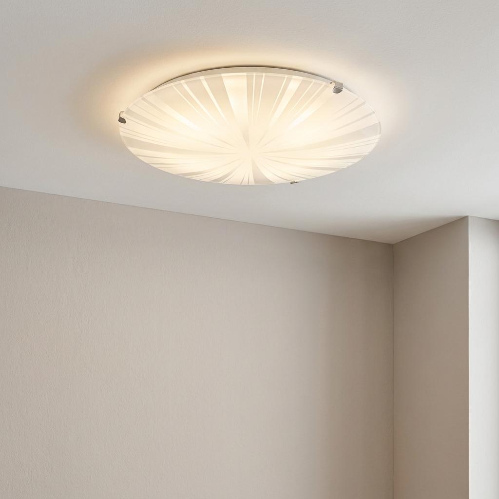 Eglo Mars 1 flush ceiling light featuring an illuminated radial striped satin glass shade on a white ceiling.