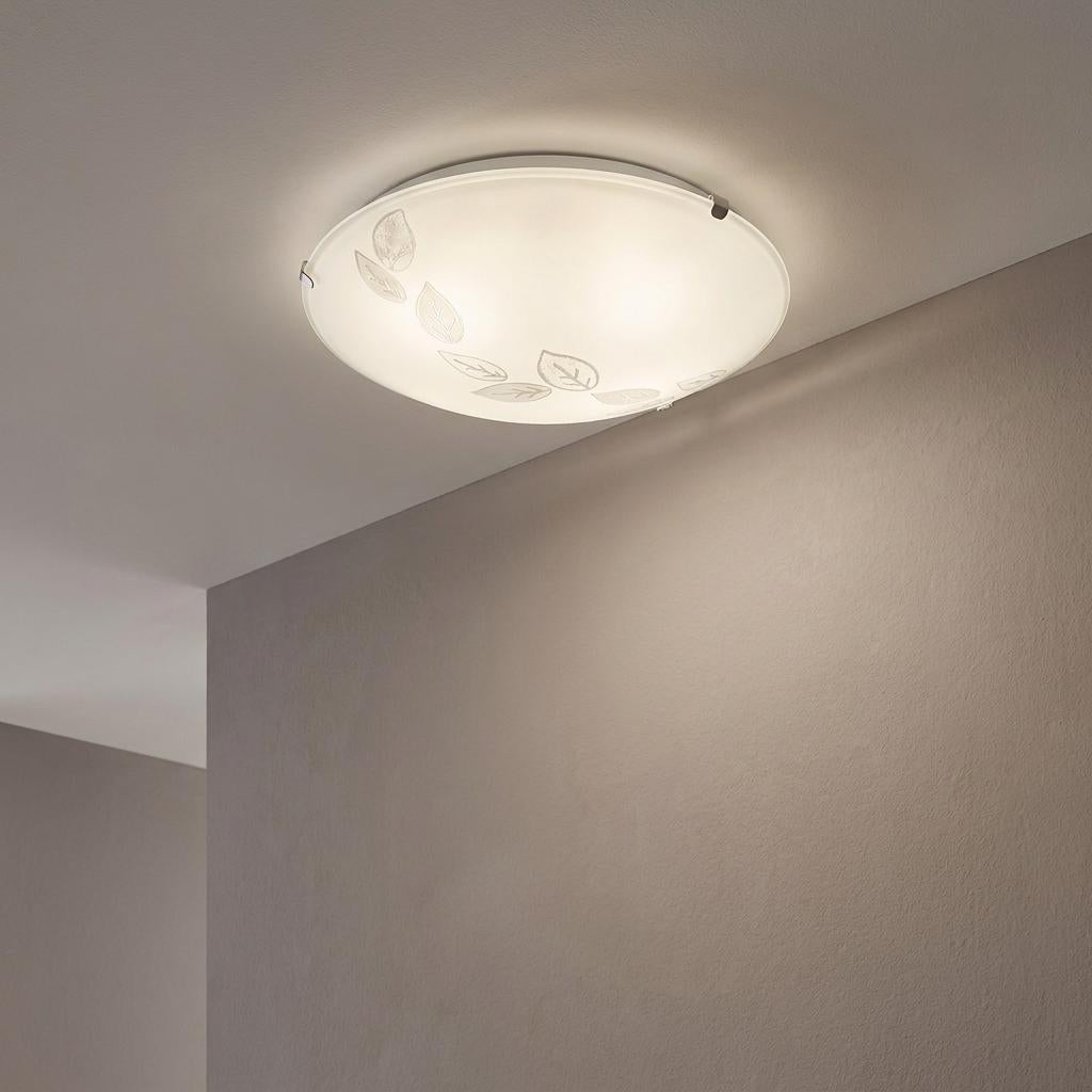 Eglo Mars flush ceiling light featuring a satin glass dome with a delicate leaf motif, illuminated on a plain ceiling.