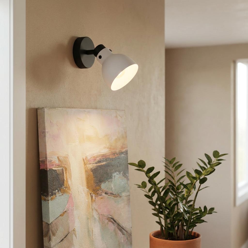 Eglo Matlock black and grey wall spotlight illuminates an abstract painting in a neutral living space.