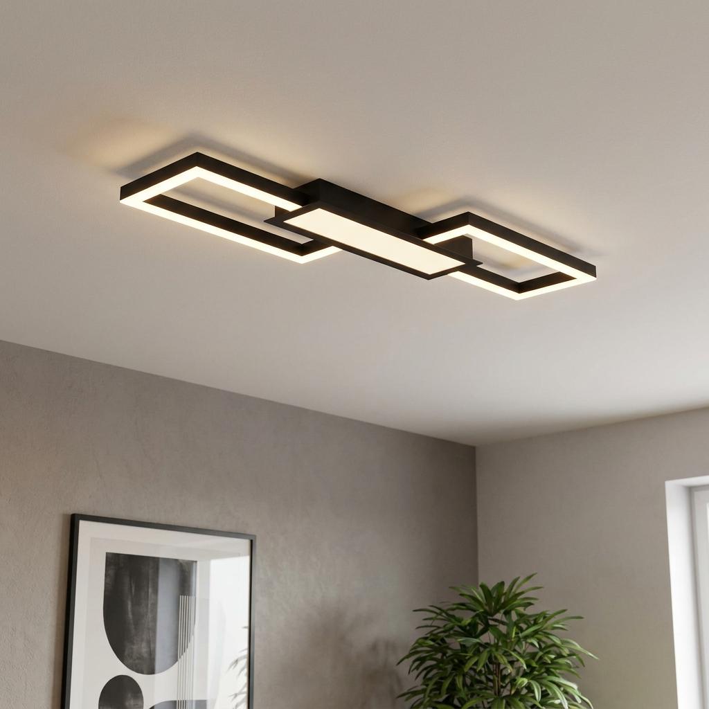 Modern black rectangular LED flush mount ceiling light illuminating a minimalist living room.