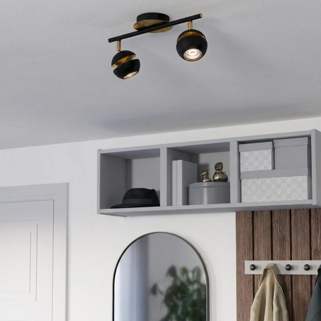 Eglo Nocito black and gold two-light bar spotlight mounted on a white ceiling in a hallway.