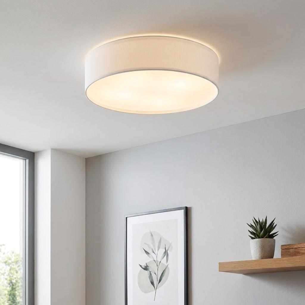 Eglo Pasteri white drum flush ceiling light with a fabric shade illuminating a modern interior room.