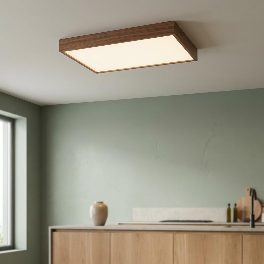 Rectangular LED flush ceiling light with a walnut frame illuminated in a modern kitchen setting.