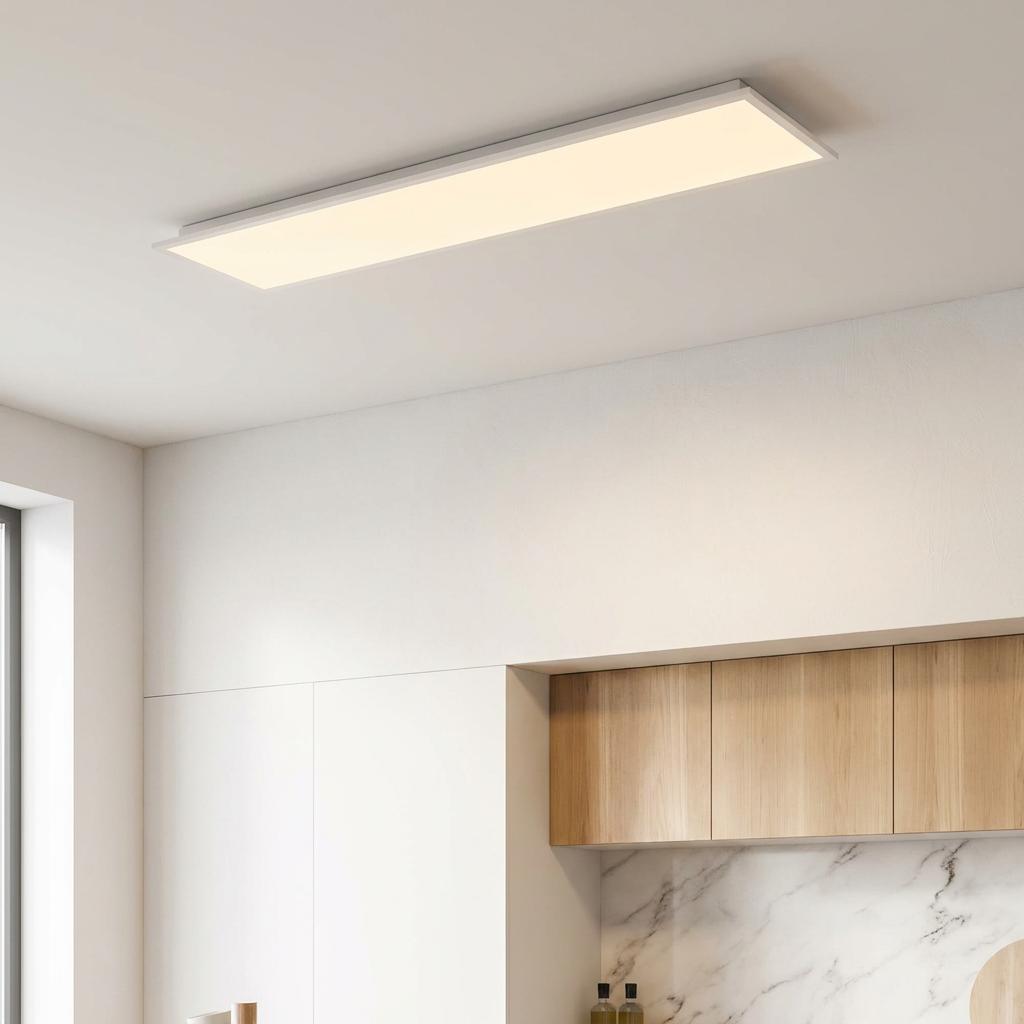 Slim white rectangular LED flush mount panel light installed on a kitchen ceiling.
