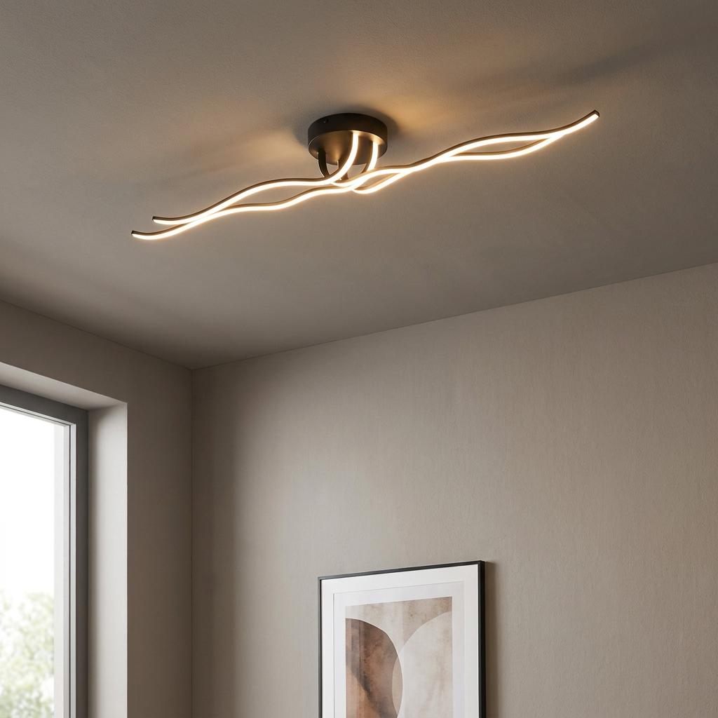 Modern black ceiling light with four wavy LED arms glowing warmly in a minimalist room.