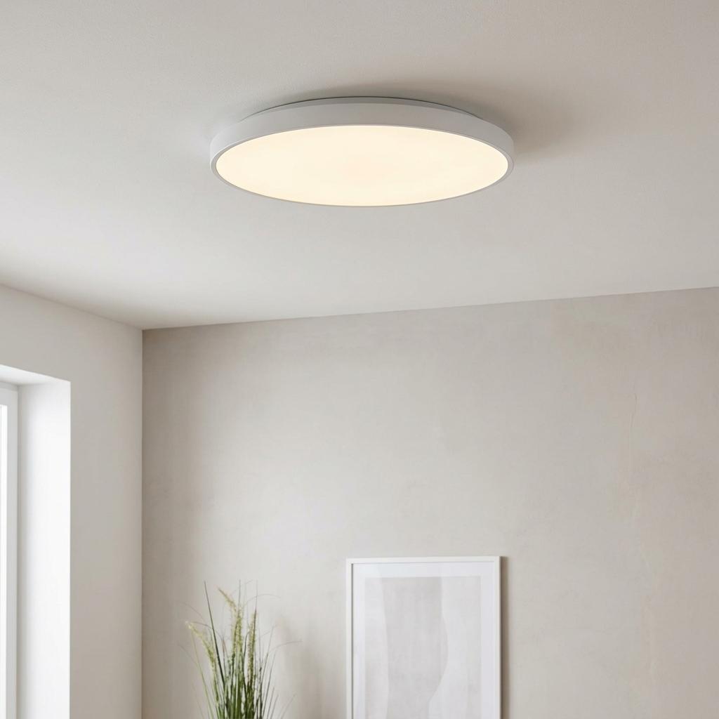 Eglo Sarsina large 60cm flush white LED ceiling light illuminated in a minimalist room with neutral walls.