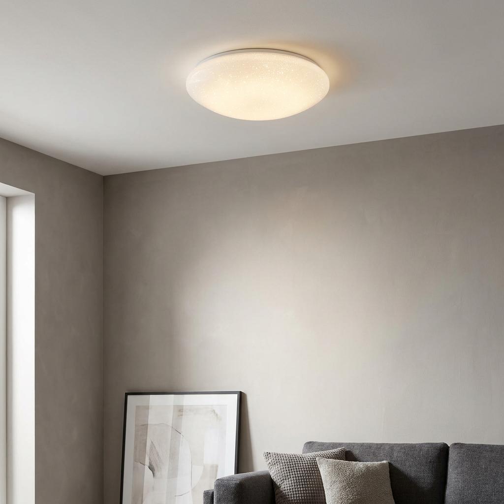 Round white flush ceiling light with a sparkling effect in a modern living room setting.