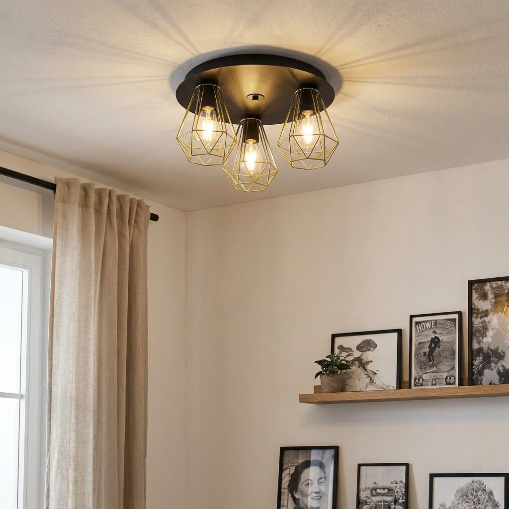 Eglo Tarbes 2 three-light ceiling flush with gold geometric wire cages illuminating a room with a gallery wall.