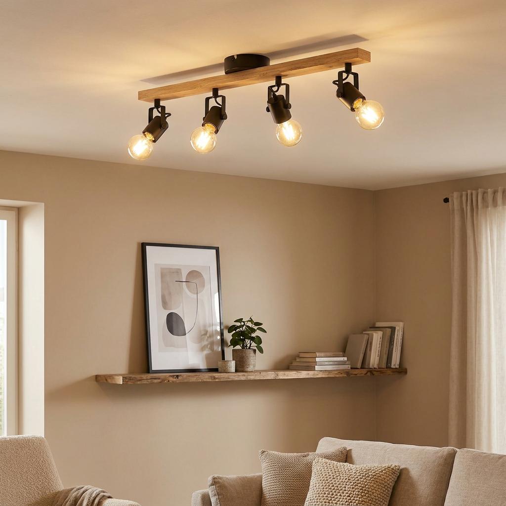Eglo Townshend 3 four-light ceiling spotlight in wood and black finish, illuminating a modern living room.