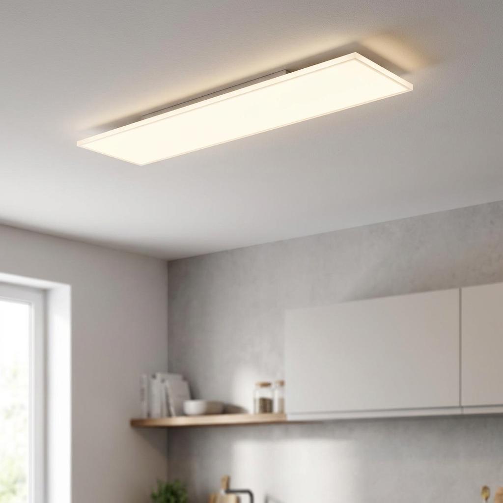 Rectangular white LED ceiling flush light glowing warmly in a modern kitchen setting.