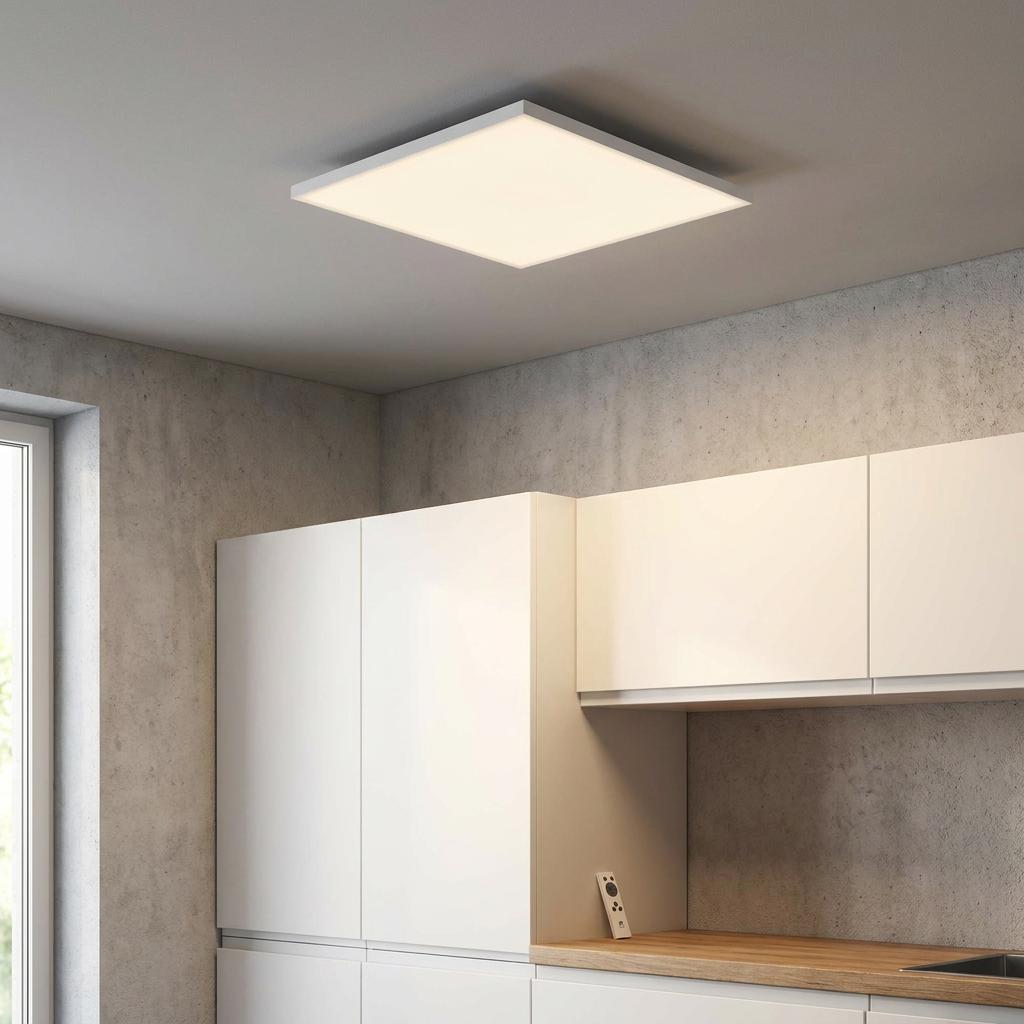 Square white LED flush ceiling light mounted on a grey ceiling above modern white kitchen cabinetry.