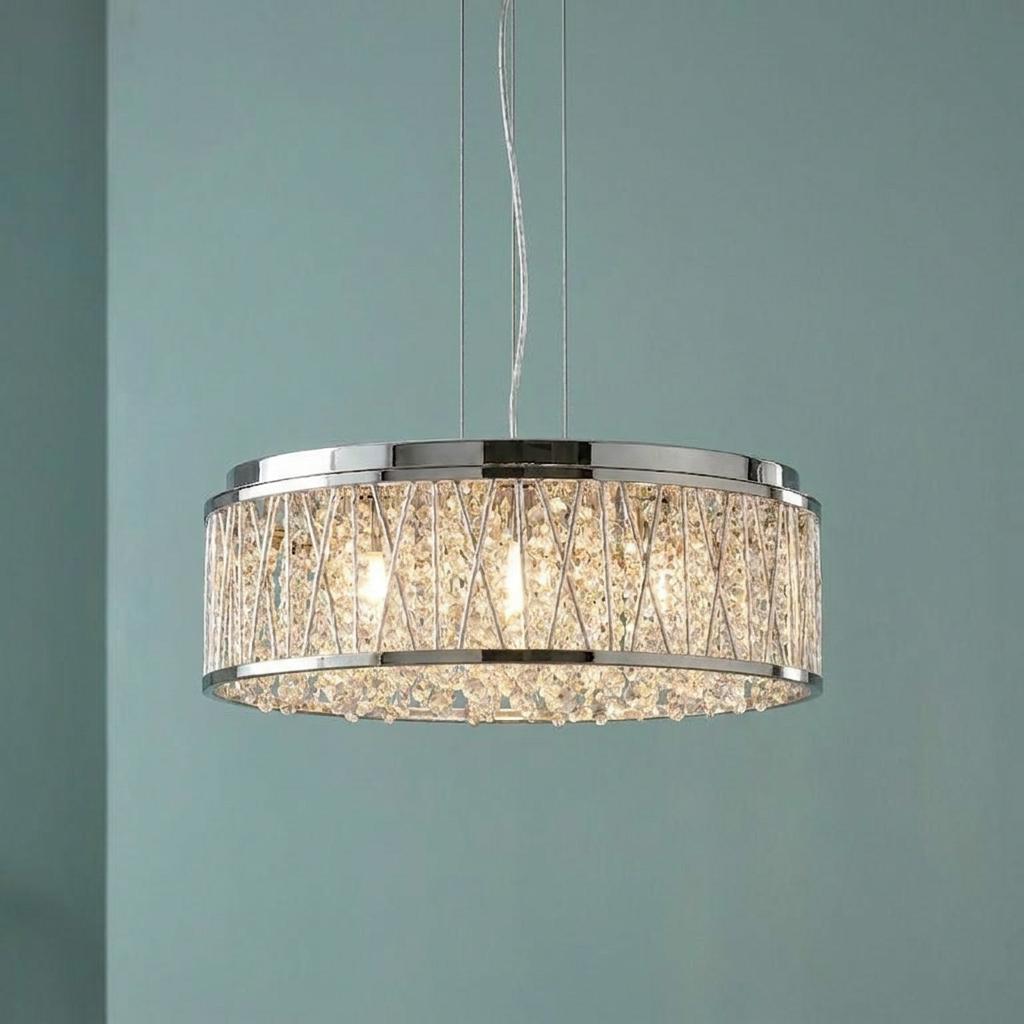 Modern Elise chrome and crystal drop pendant light fixture illuminated against a teal wall.
