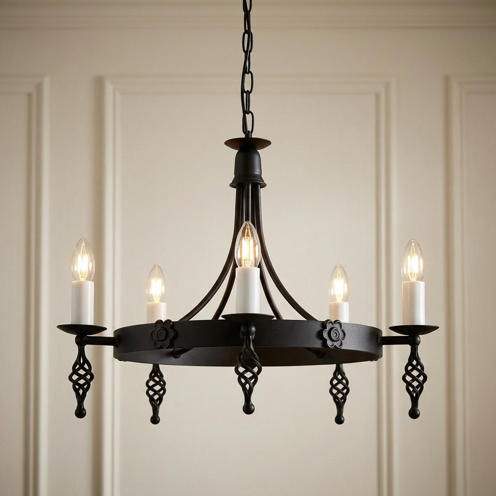 Elstead Belfry 5-light black chandelier with candle bulbs and twisted iron details against a neutral panelled wall.