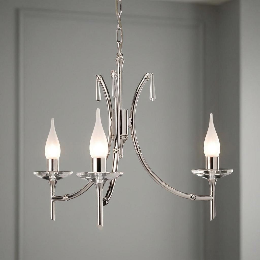 Three-light polished nickel chandelier with frosted flame bulbs and crystal accents against a neutral wall.