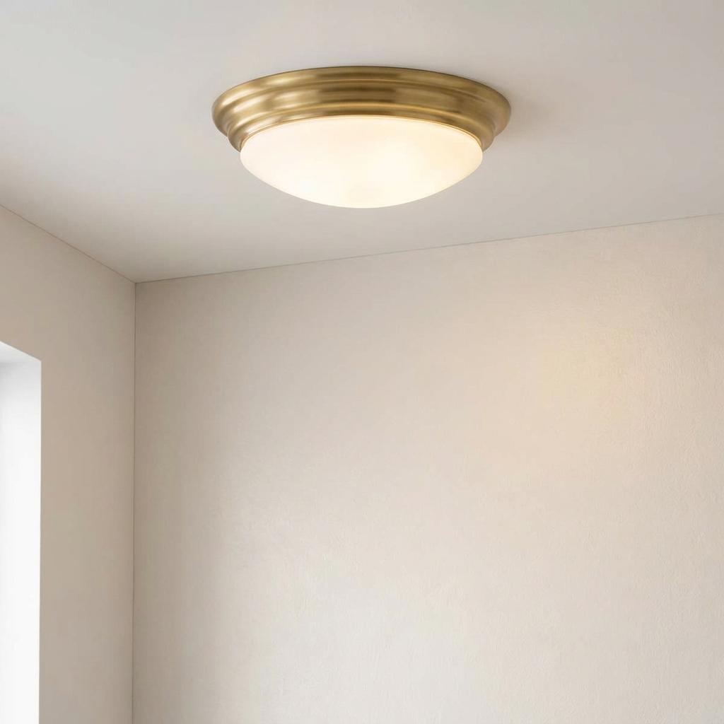 Elstead Brompton brass bathroom flush mount ceiling light with a frosted glass opal dome.