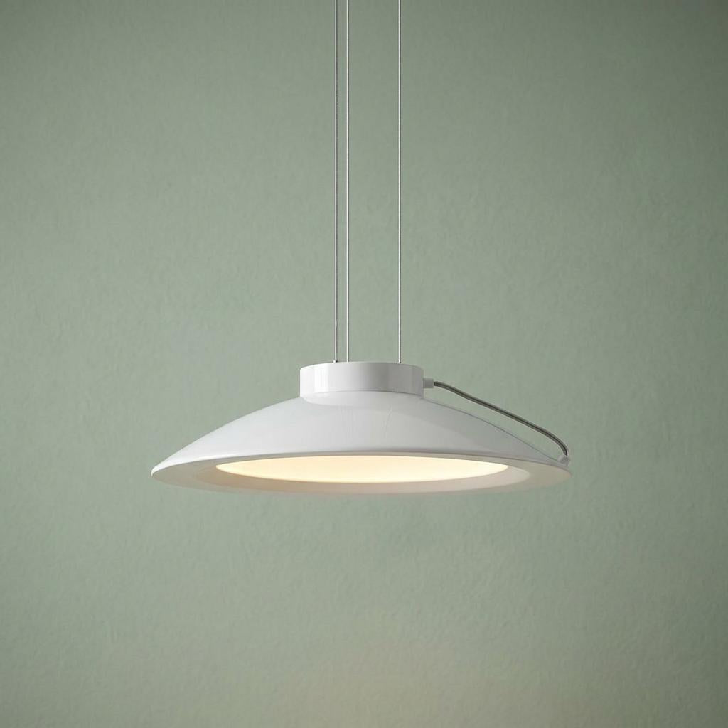 Large white saucer-shaped LED pendant light suspended by thin wires against a muted green wall.