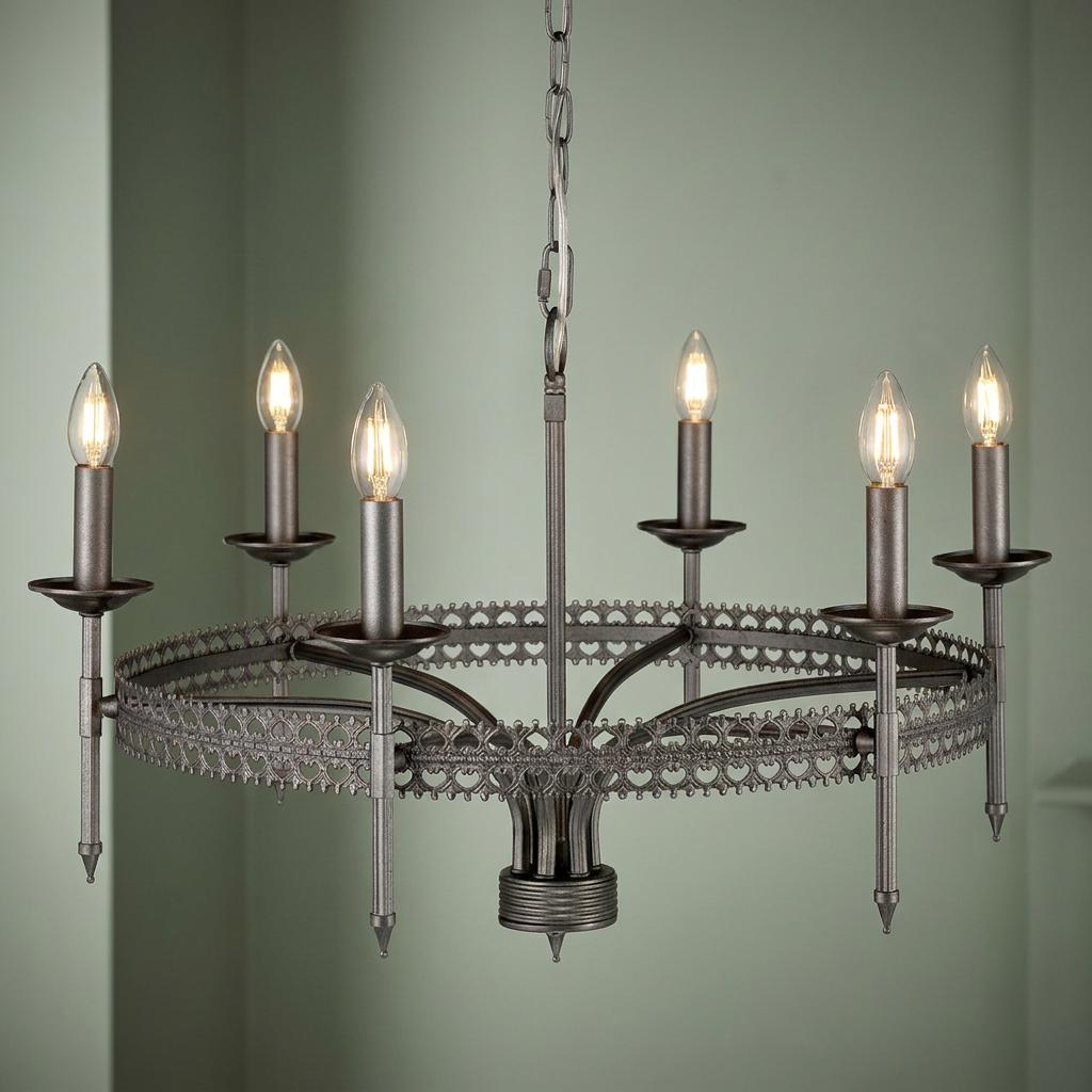 Six-light silver chandelier with an ornate filigree crown design and candle bulbs against a sage green background.