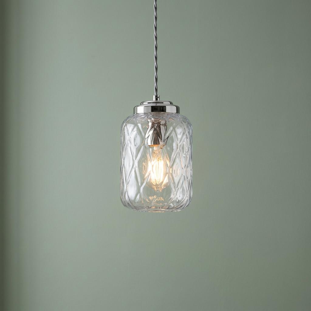Elstead Sola 1-light nickel pendant featuring a diamond-patterned glass shade against a sage green wall.