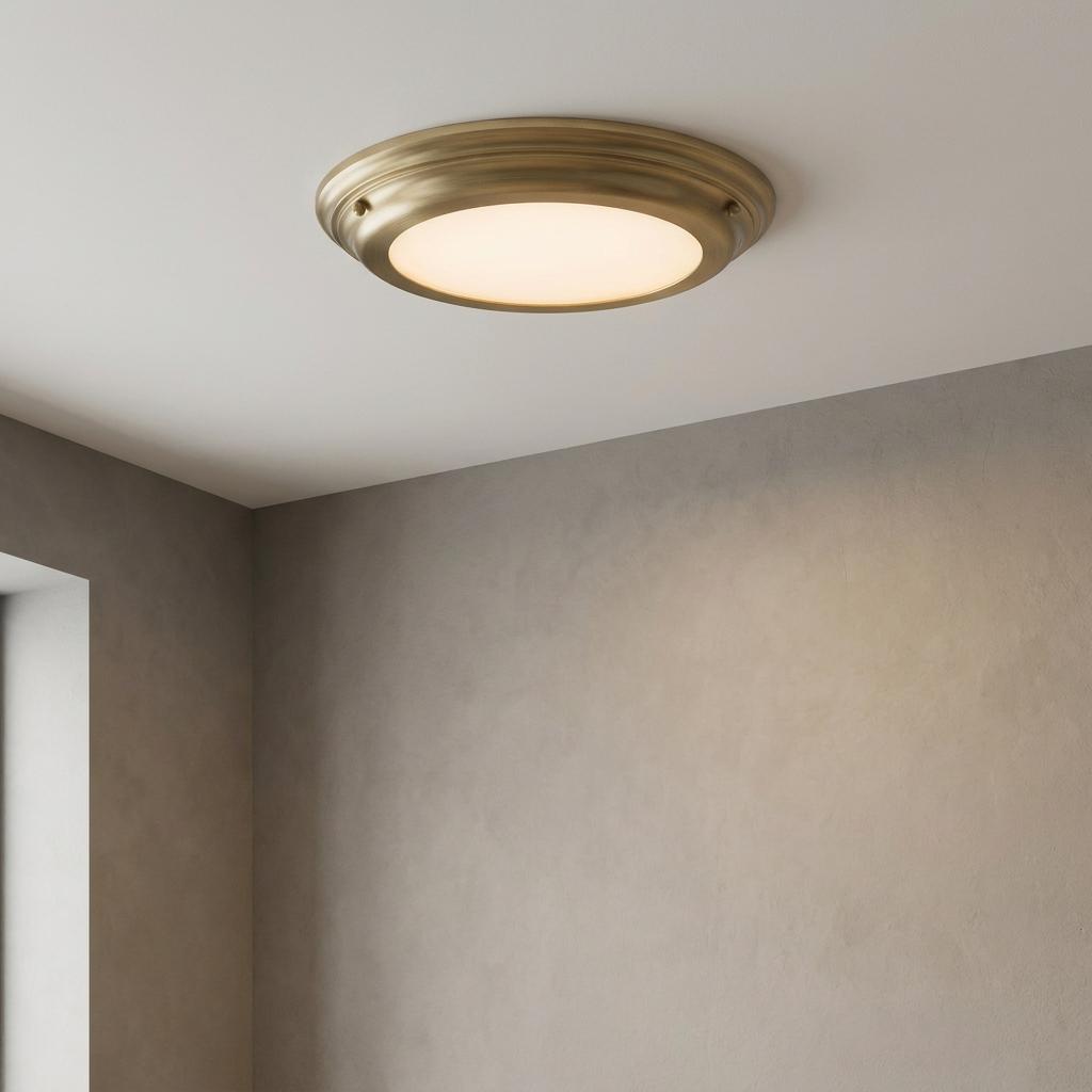 Elstead Lighting Welland flush mount brass ceiling light with a frosted diffuser on a white ceiling.
