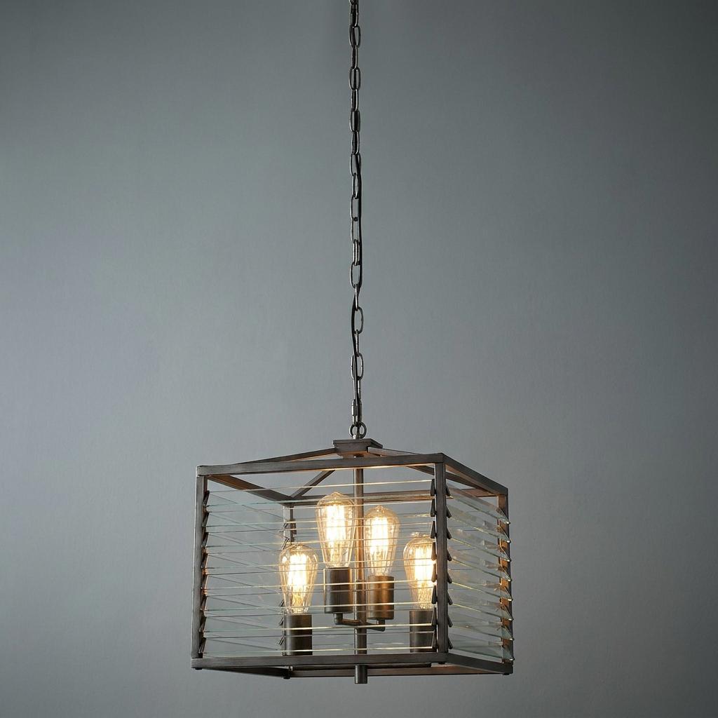 Gunmetal pendant light with a square frame and glass louvre slats, housing four bulbs against a grey background.