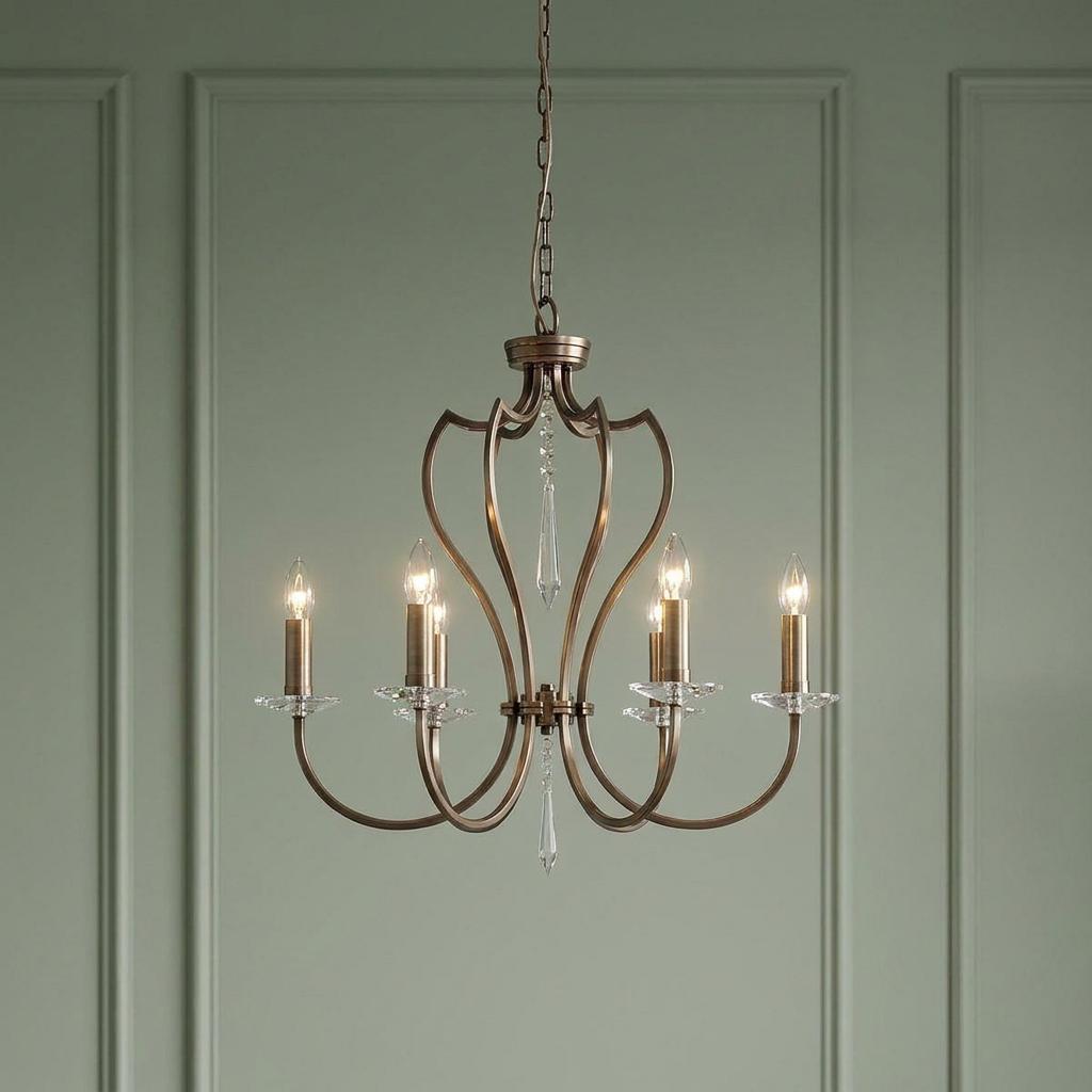 Elstead Pimlico 6-light dark bronze chandelier with elegant curved arms and crystal accents against a green wall.