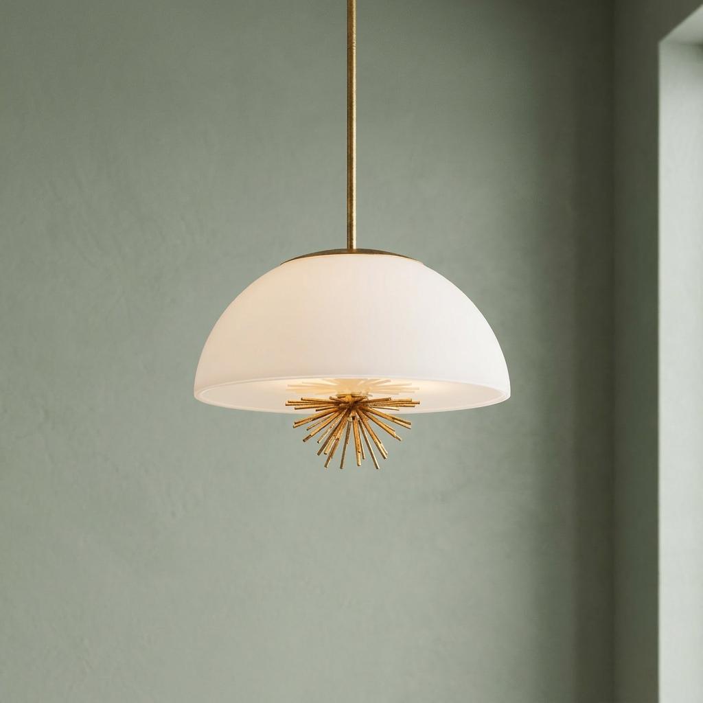 White dome glass pendant light with a gold starburst finial hanging against a muted green wall.