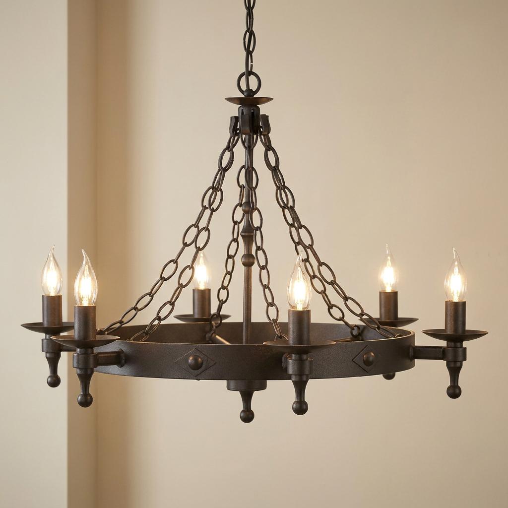 Rustic graphite six-light chandelier with a medieval-style ring frame and chain suspension against a plain wall.