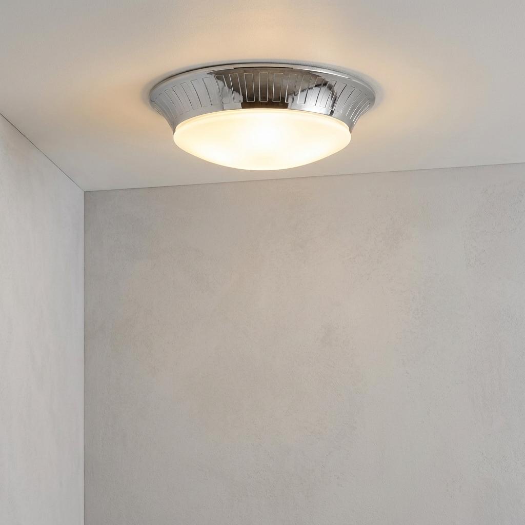 Elstead Whitby polished chrome flush ceiling light with an opal glass diffuser illuminated in a bathroom setting.