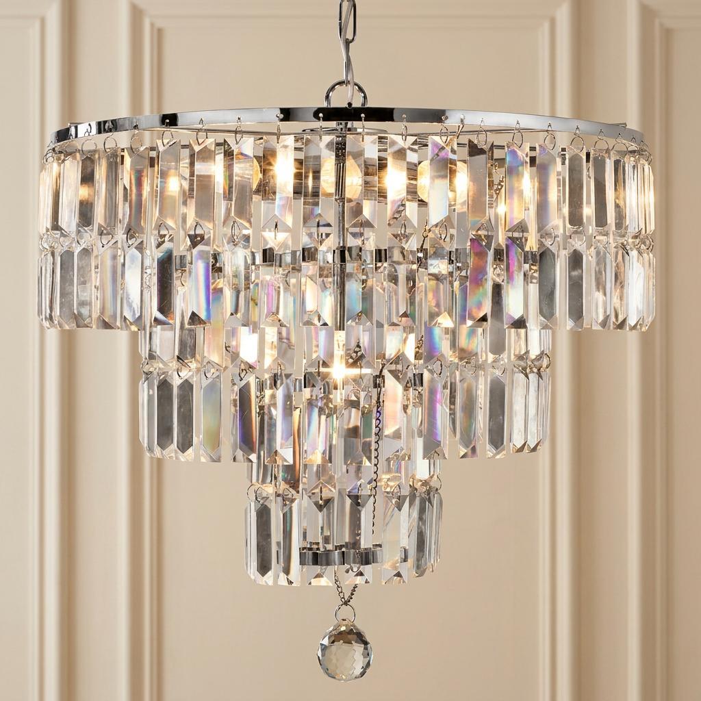 Tiered Empire chandelier with polished chrome frame and rectangular crystal prisms emitting a warm glow.