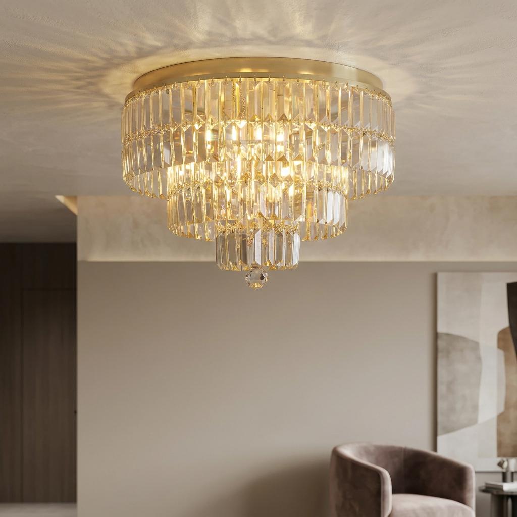 Tiered satin brass and crystal flush ceiling light casting a patterned glow in a modern room.