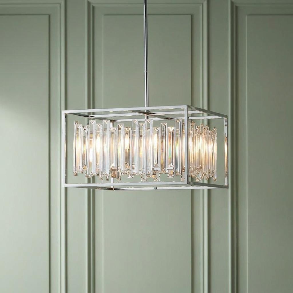 Endon Acadia chrome pendant light with crystal prisms in a rectangular frame against a green paneled wall.