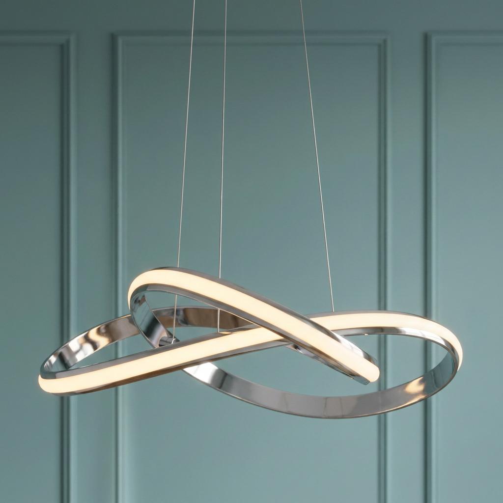 Modern chrome pendant light with intertwined LED loops glowing against a teal paneled wall.