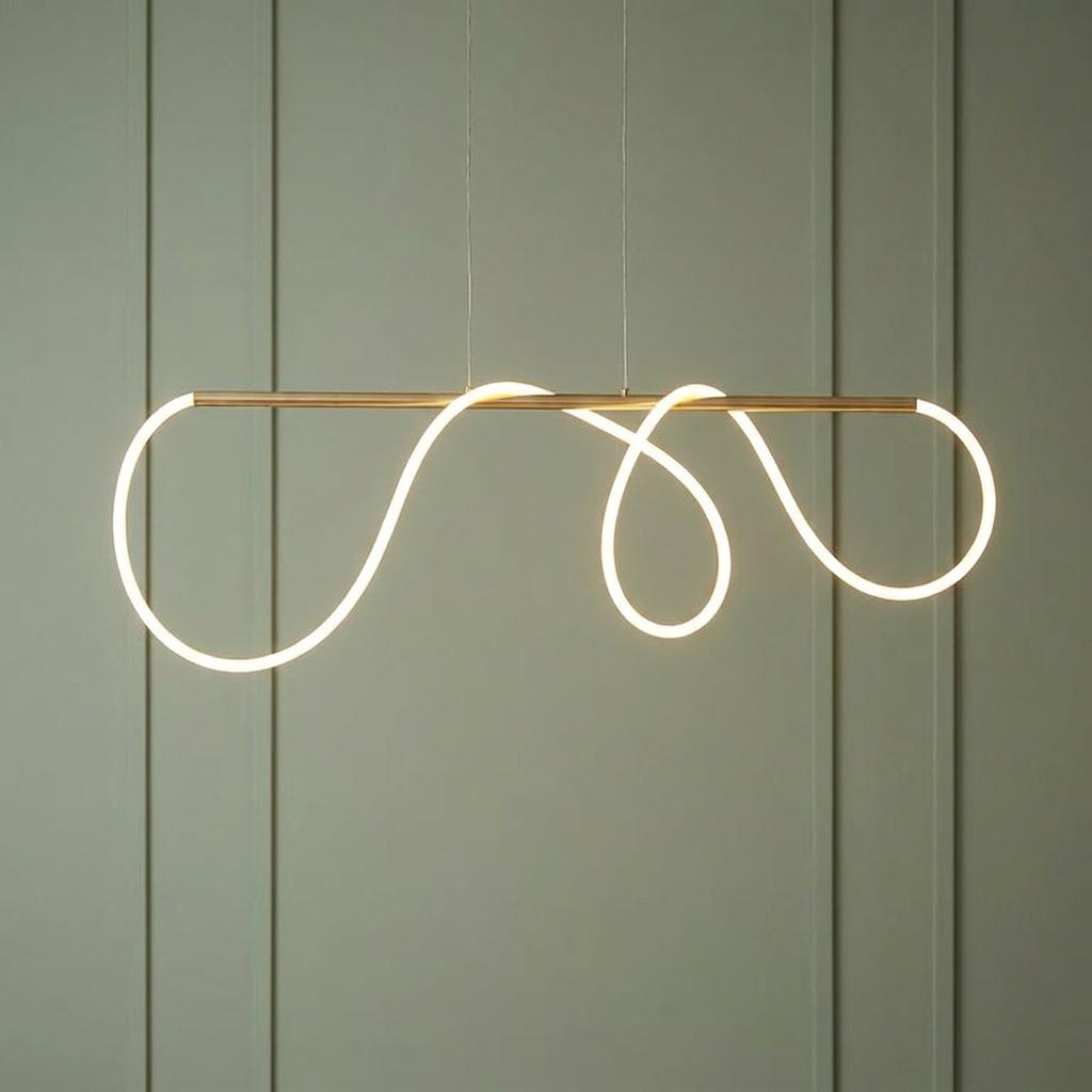 A modern ceiling pendant with a glowing white LED loop wound around a satin gold bar against a green wall.