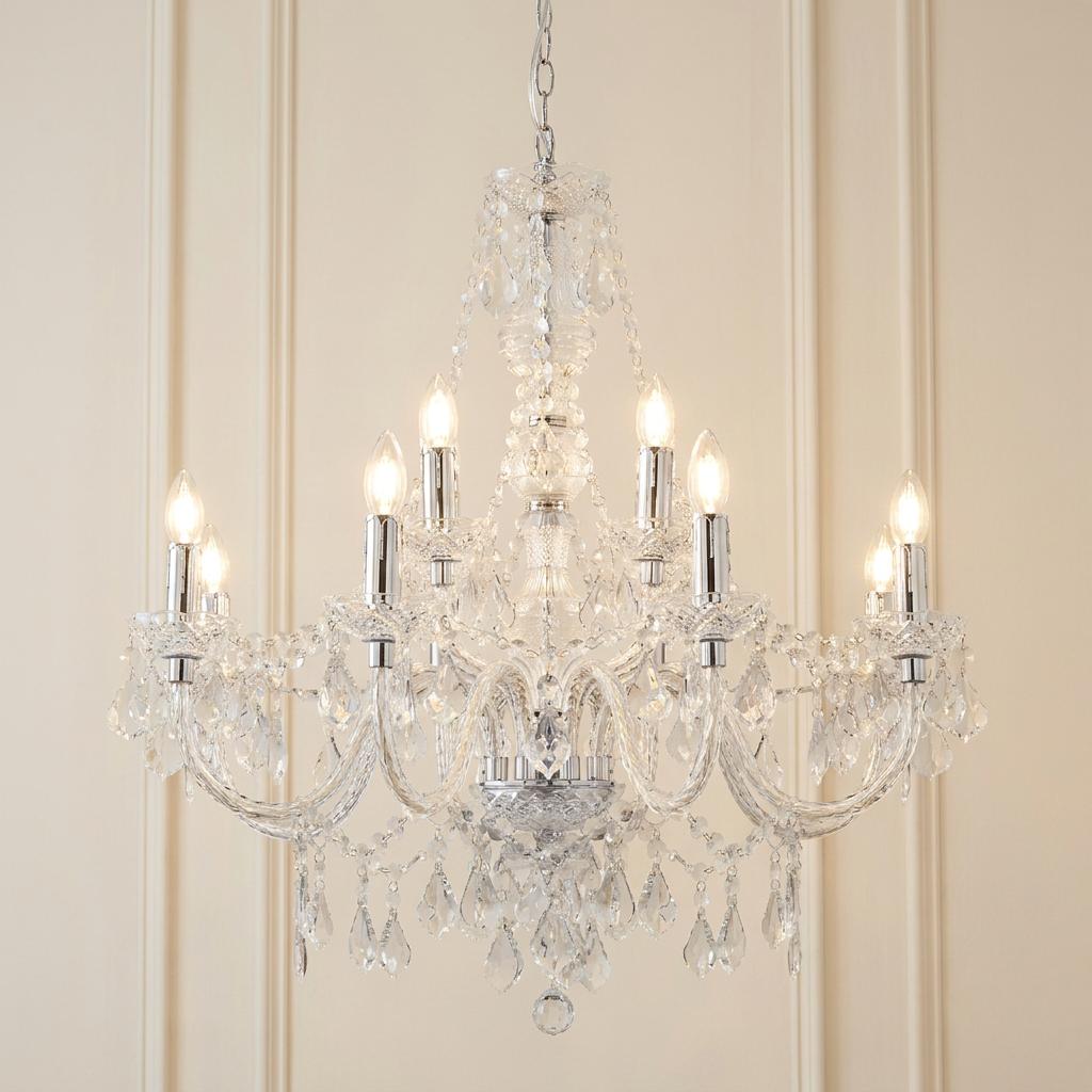 Endon Clarence 12-arm chrome and clear acrylic chandelier with lit bulbs against a neutral paneled wall.