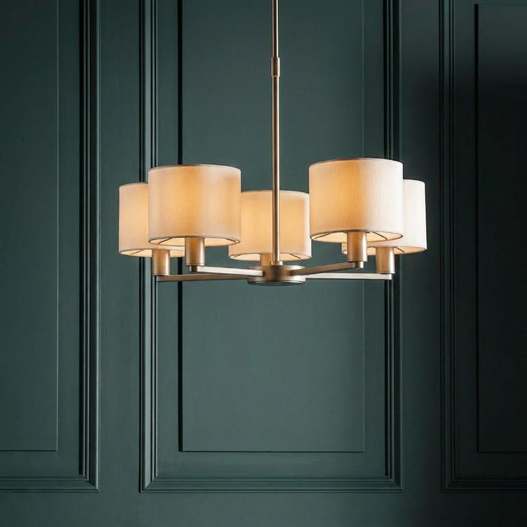 Endon Daley 5-light nickel ceiling pendant with glowing cream shades against a dark teal wood paneled wall.