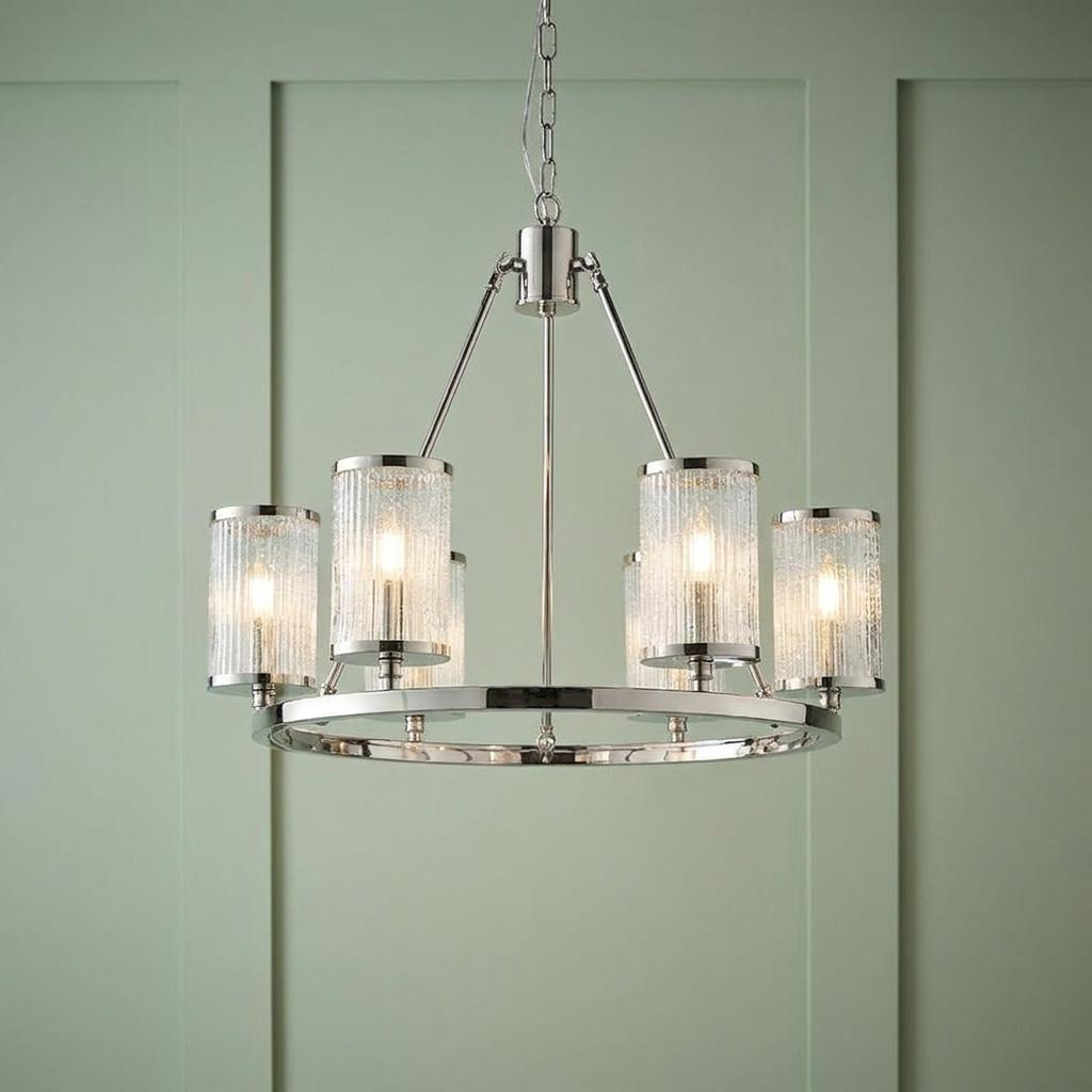 A nickel 6-light pendant chandelier with ribbed glass shades hangs against a sage green paneled wall.