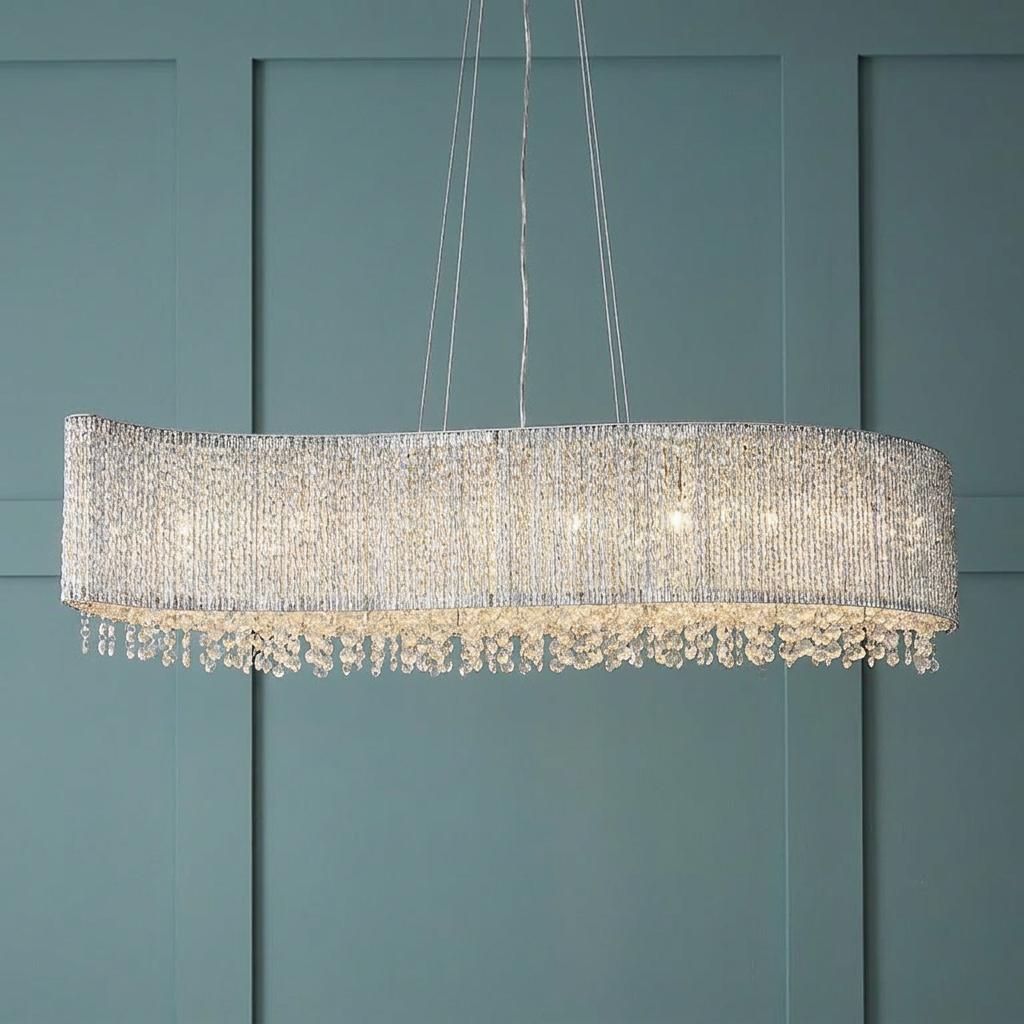 Endon Galina 8 light chrome linear ceiling pendant with crystal droplets against a teal paneled wall.