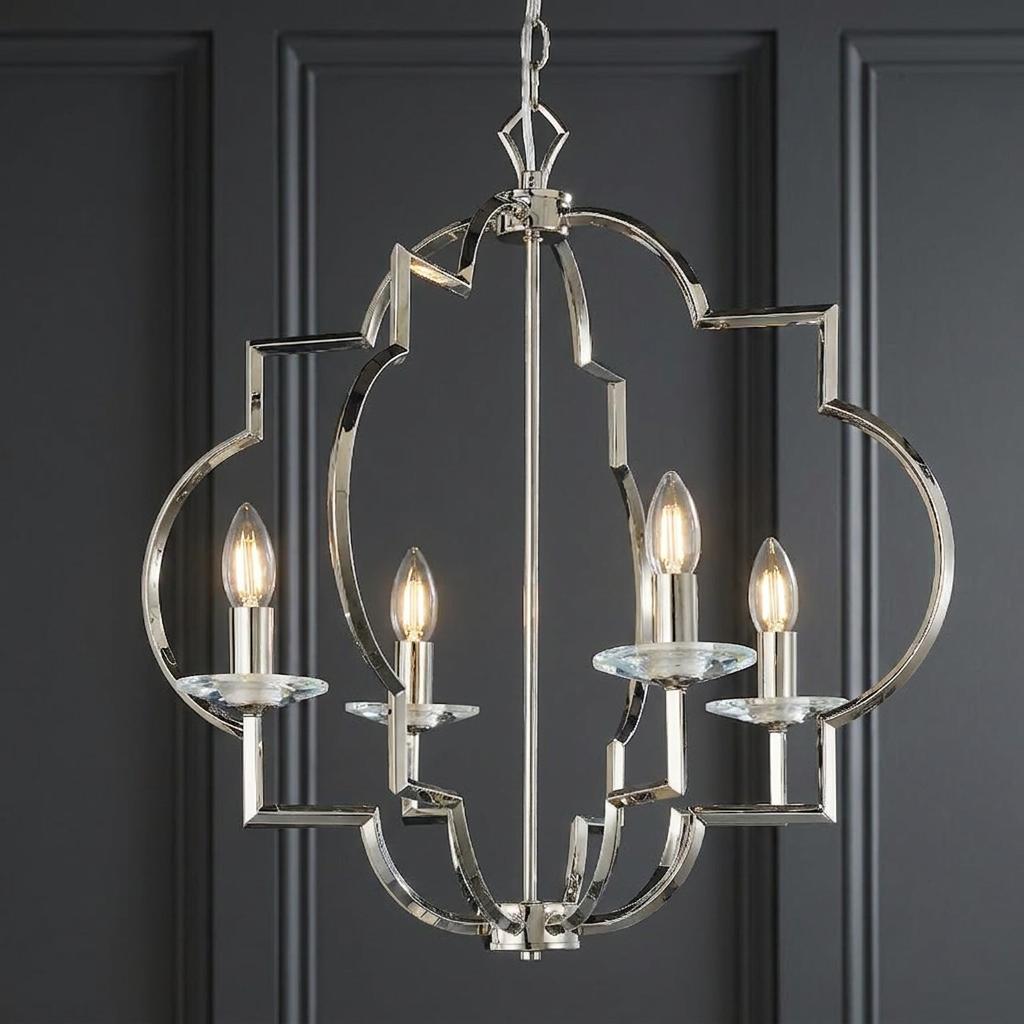 Four-light polished nickel geometric pendant with candle bulbs against a dark paneled wall.