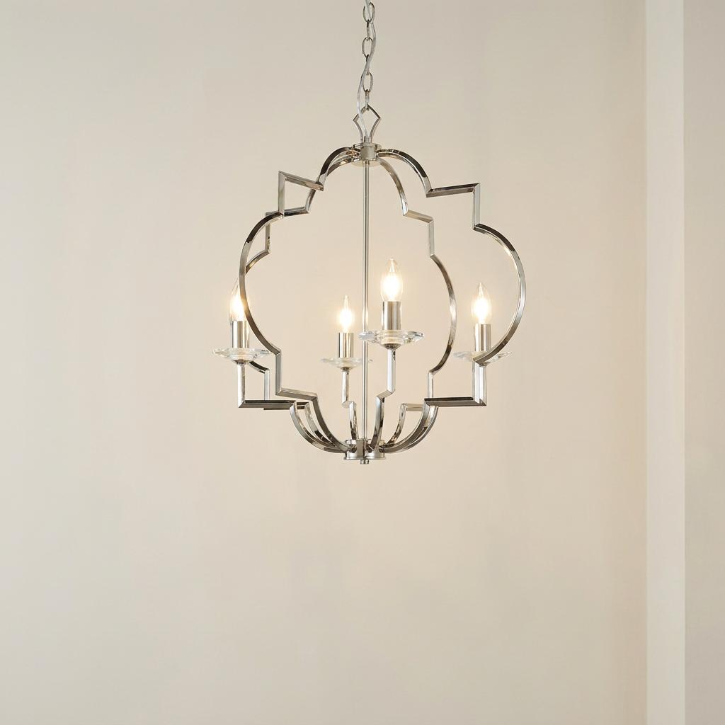 Polished nickel 4-light ceiling pendant with a geometric open frame and candle-style bulbs against a neutral wall.