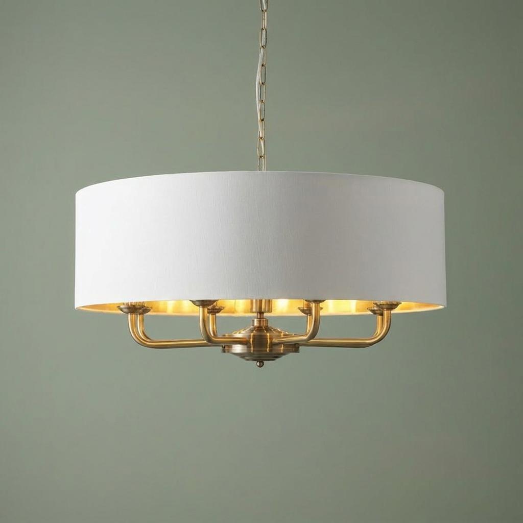 Antique brass 8-light pendant with a large white drum shade and warm metallic interior.