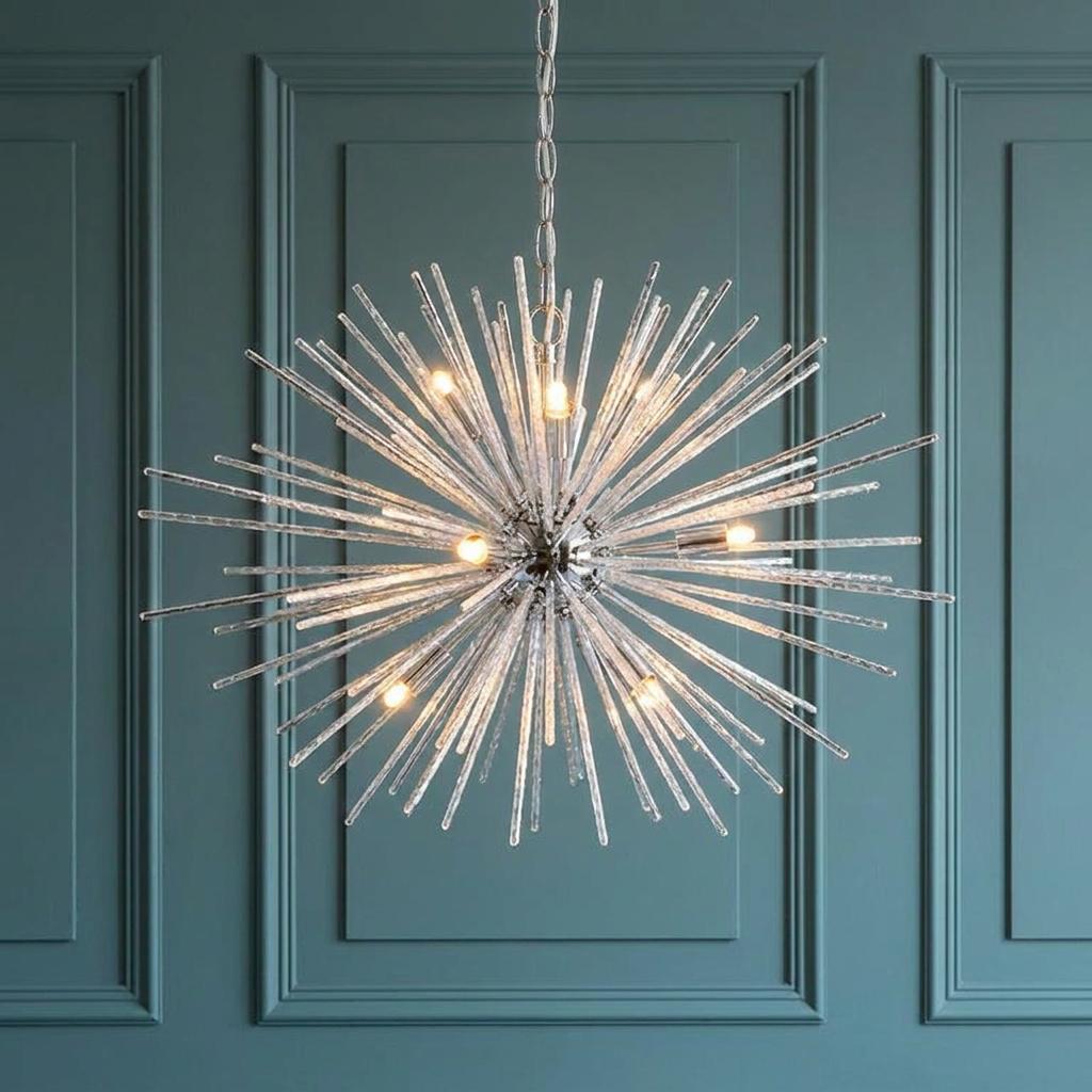 Starburst-style chrome chandelier with glass spikes and nine lights, hanging against a teal paneled wall.