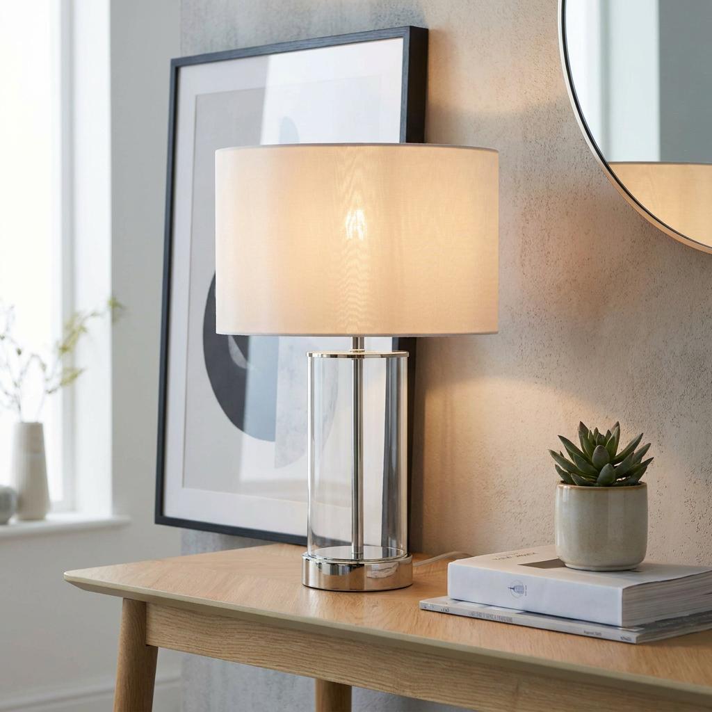 Endon Lessina 1 light touch table lamp with clear glass base and white shade on a wooden desk.