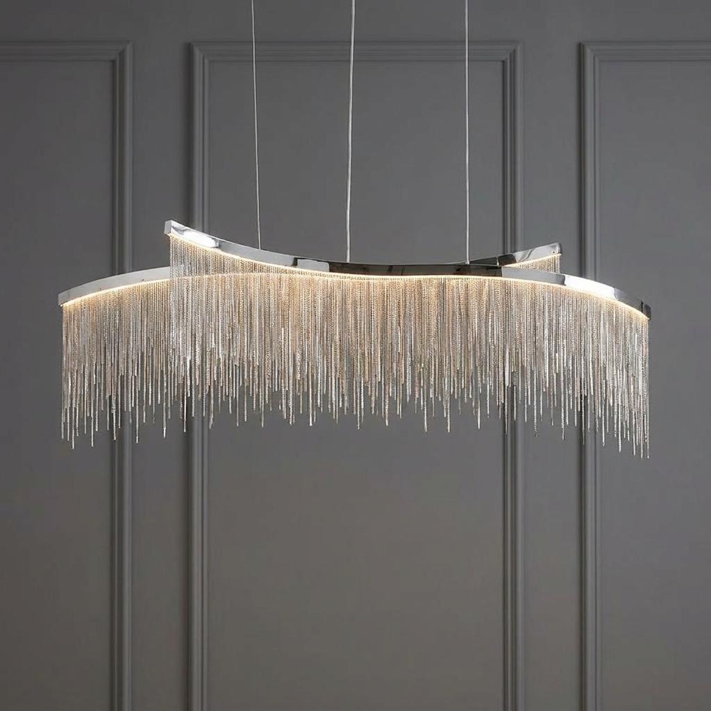 A modern linear ceiling pendant with a polished chrome frame and cascading silver chain fringe against a grey wall.