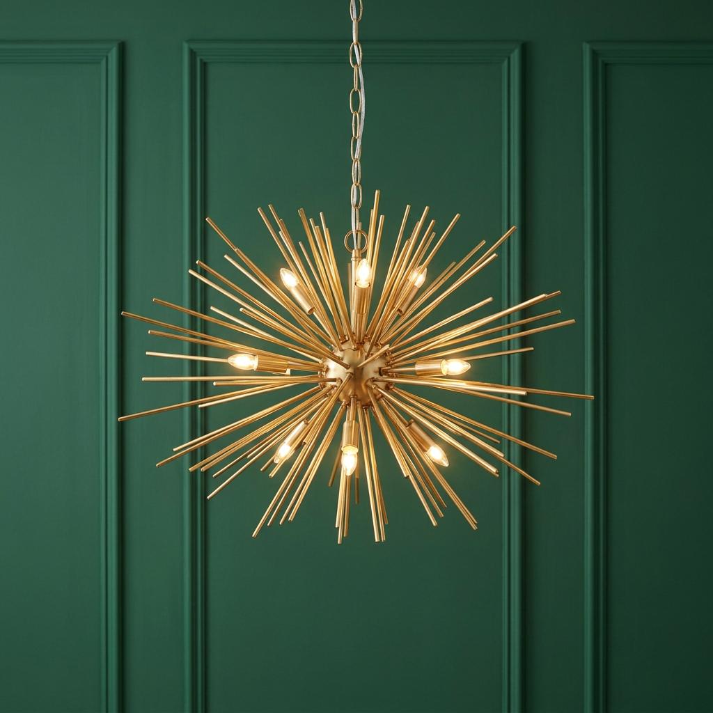 Gold starburst pendant light with nine bulbs, displayed against a forest green paneled wall.