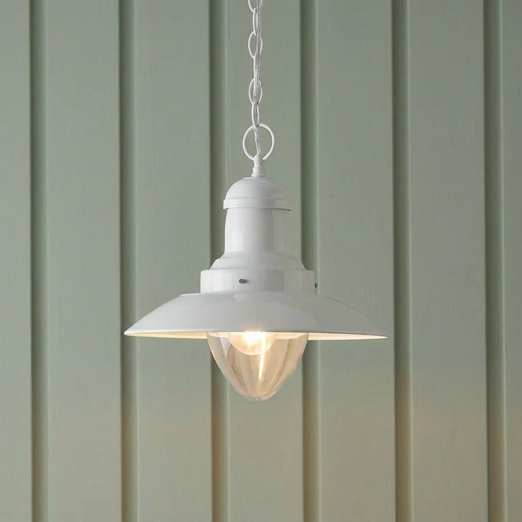 Cream industrial pendant light with clear glass diffuser hanging against a pale green slatted wall.