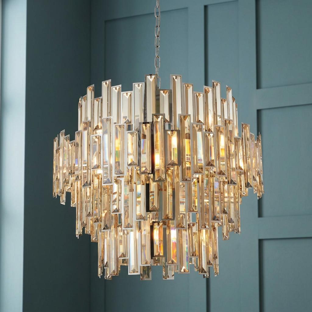 Viviana 15-light chandelier with tiered champagne tinted crystal baguettes against a teal panelled wall.