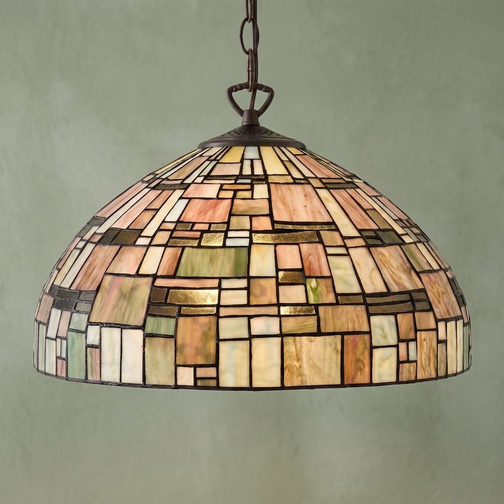 Tiffany-style pendant light with a geometric stained glass dome shade in amber, green, and pink earth tones.