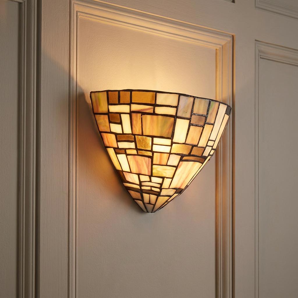 Lit Falling Water Tiffany wall sconce with geometric amber and cream stained glass on a paneled wall.