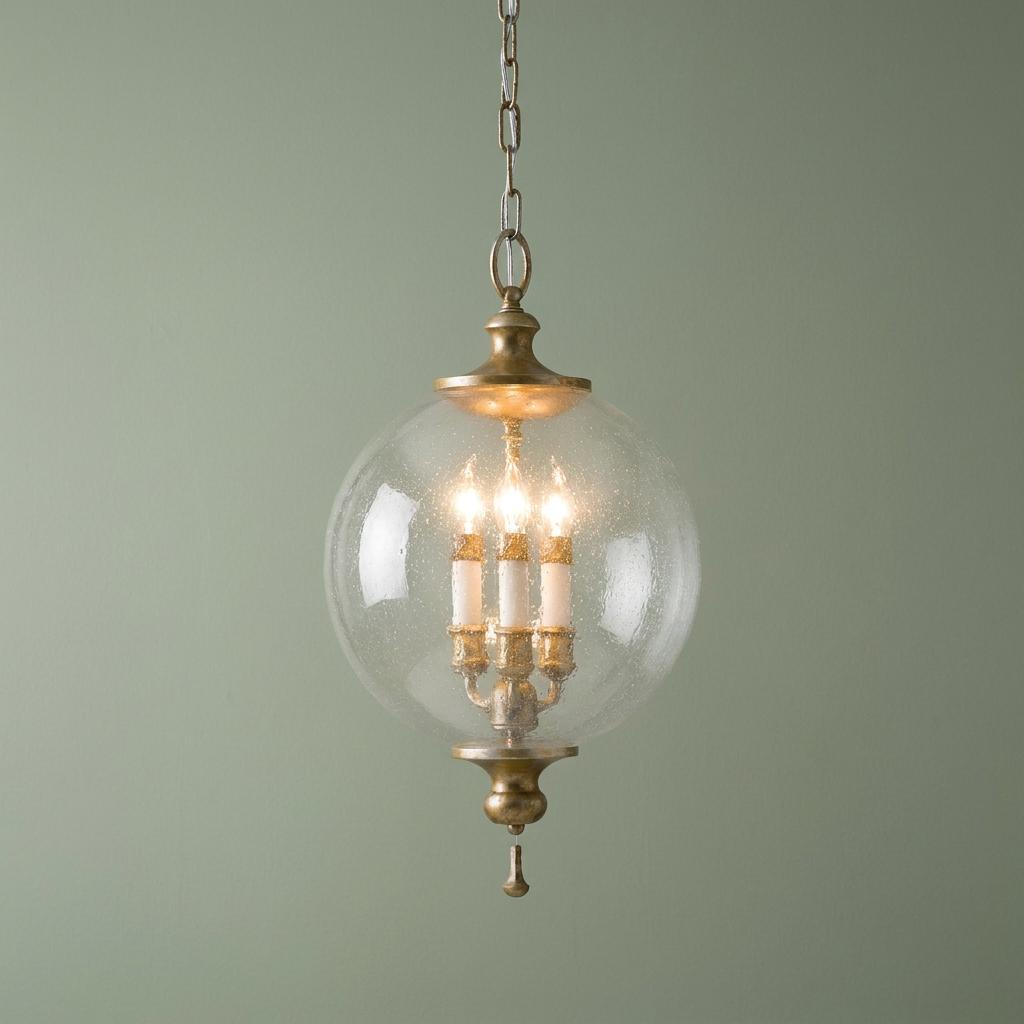 Feiss Argento ceiling lantern with oxidized silver leaf finish and a clear seeded glass globe on a green background.